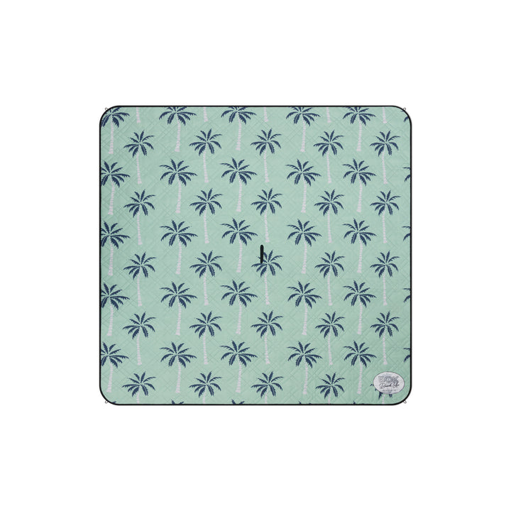 Patterned picnic mat with palm tree design on a light green background