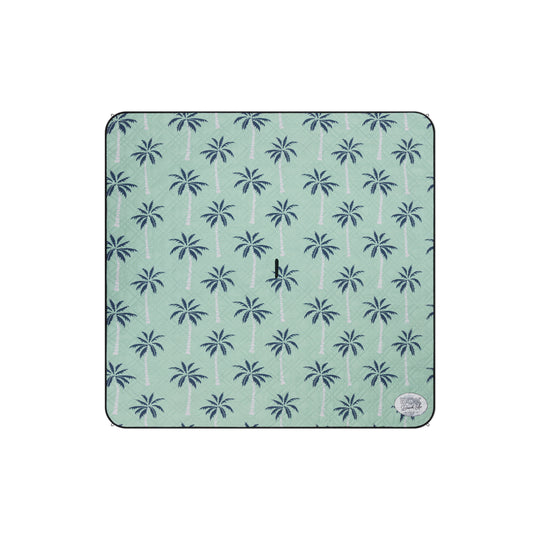 Patterned picnic mat with palm tree design on a light green background